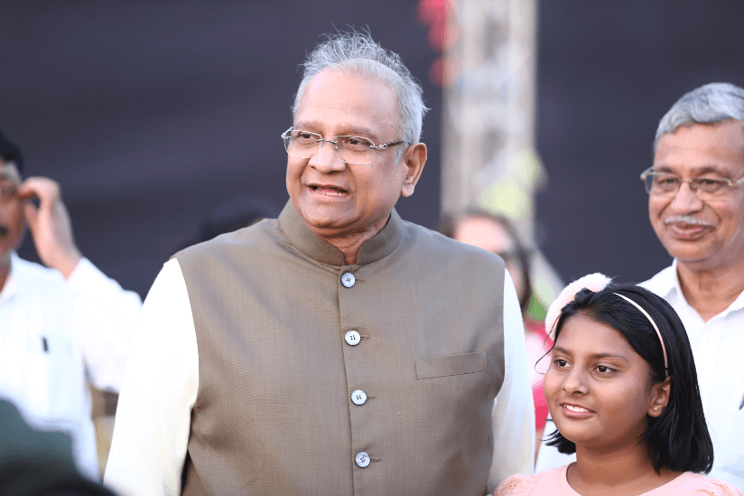 Bhupeshbhai standing with a family after treatment