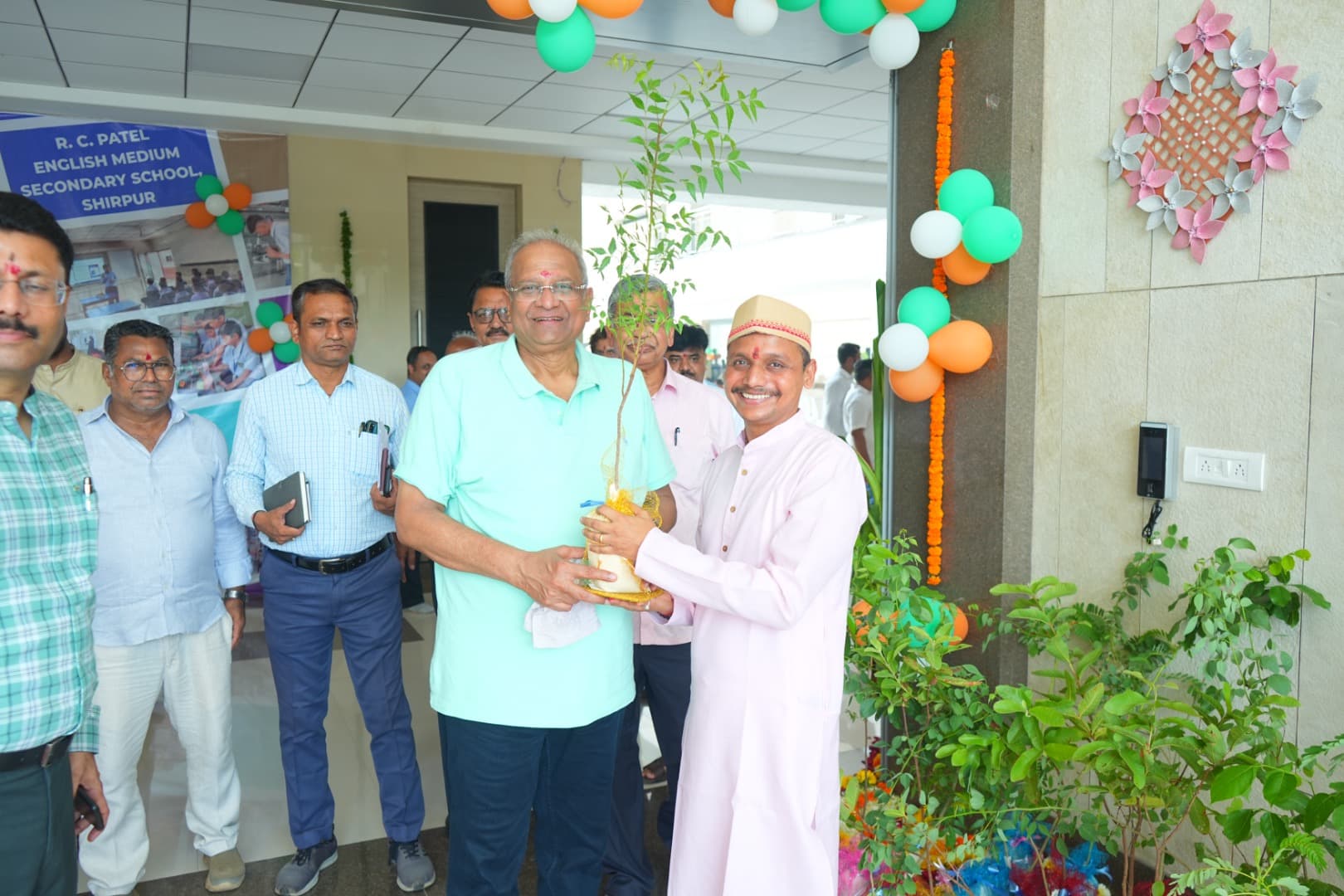 Bhupeshbhai receiving a sapling at a village event